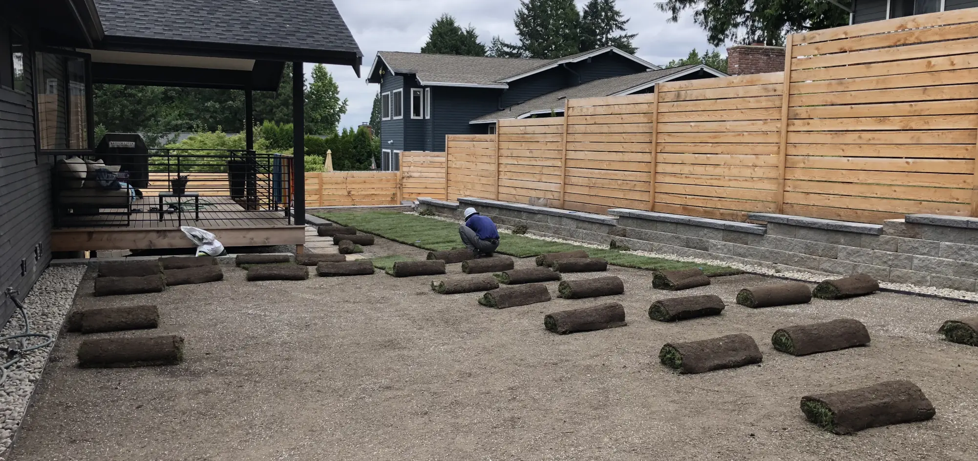 Landscape construction laborer installing new lawn sod, Kent, WA Landscape construction laborer installing new lawn sod, Kent, WA