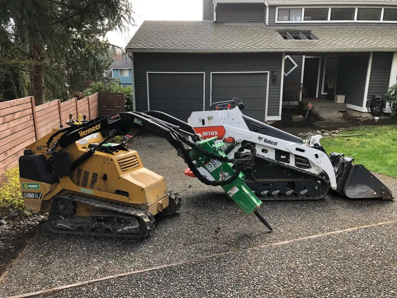 Before replacement: older driveway with construction equipment. Before replacement: older driveway with construction equipment.