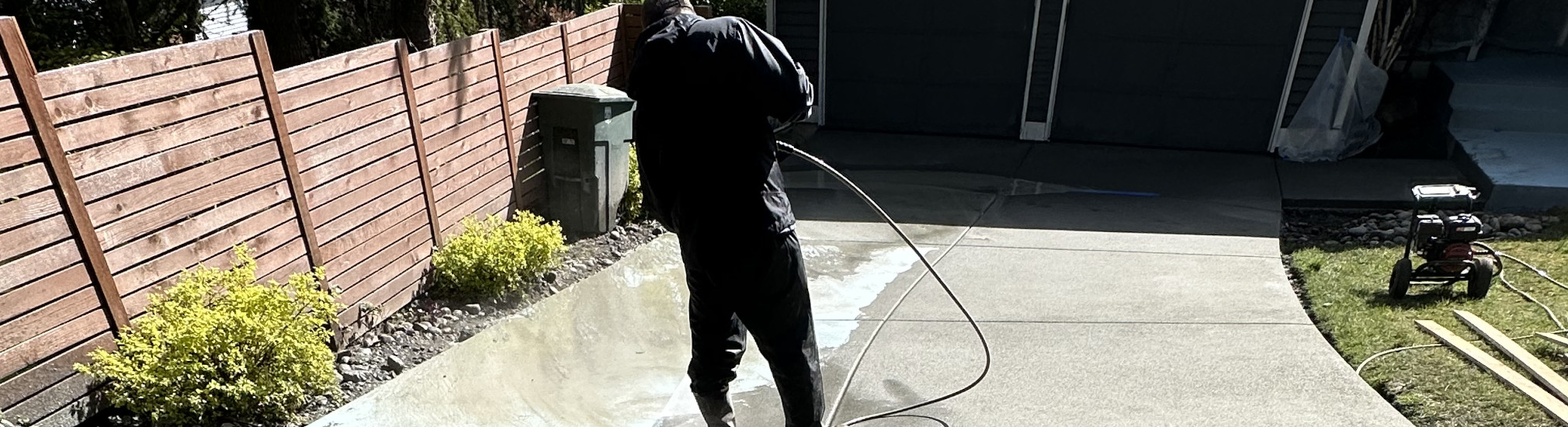 Spraying down a new concrete driveway. Spraying down a new concrete driveway.